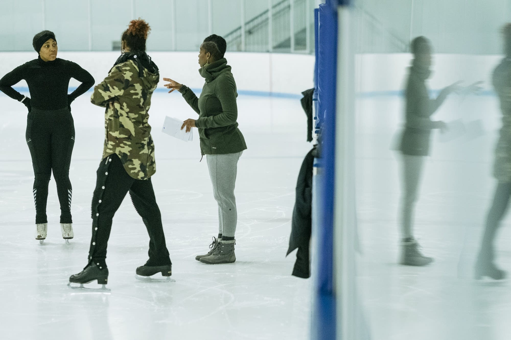 Brownbody skaters talk during rehearsal.