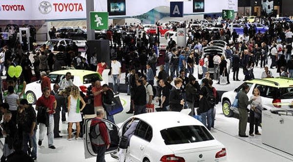 People visit the Paris Auto Show on October 1st, 2010, on the event's opening day.