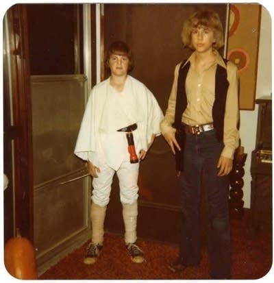 Two boys wear Star Wars Halloween costumes.