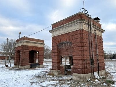 Two brick gatehouses, surrounded by snowy ground
