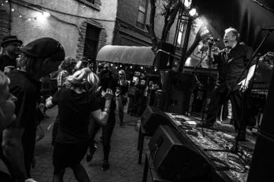 A rock band performing on an outdoor stage