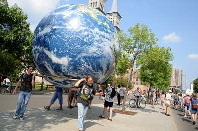 Protesters carry giant globe