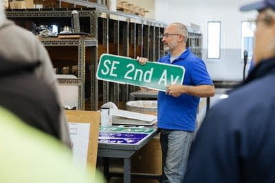 Man holding a street sign
