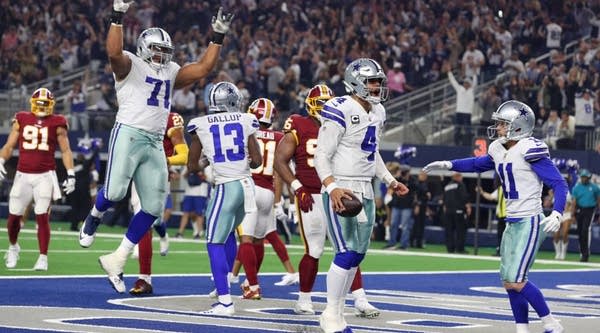 The Dallas Cowboys including La'el Collins #71 and Cole Beasley #11 celebrate the fourth quarter touchdown by Dak Prescott #4 against the Washington Redskins at AT&T Stadium on November 22, 2018 in Arlington, Texas.