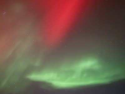 Greens and reds fill the night sky.