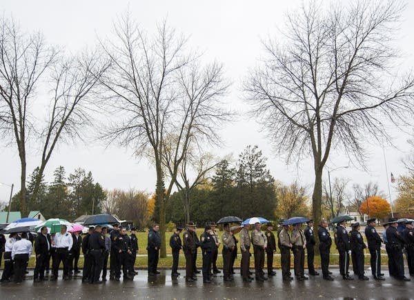 Law enforcement officers waited in the rain.