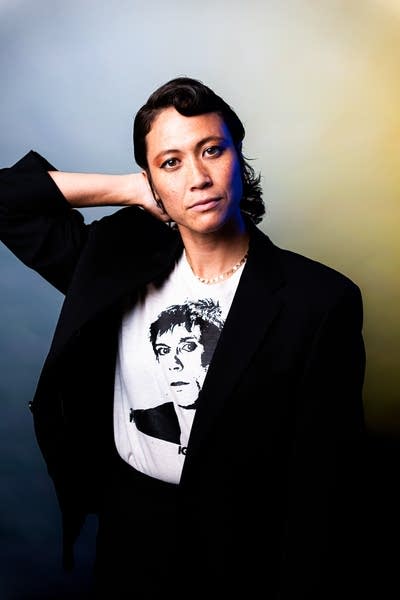 A woman poses for a studio portrait