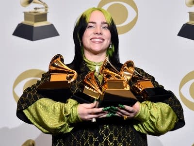 Billie Eilish with some of her awards at the 62nd Annual GRAMMYs.
