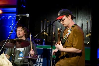 a drummer and guitarist playing on stage