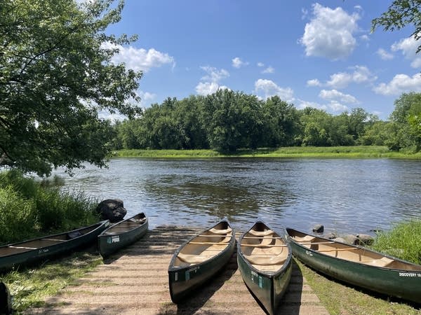 Canoes sit at a public landing on the St. Croix River