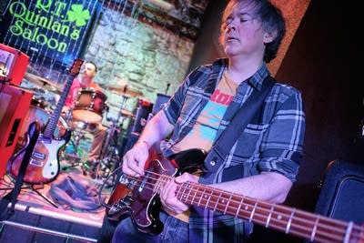 A musician plays bass onstage