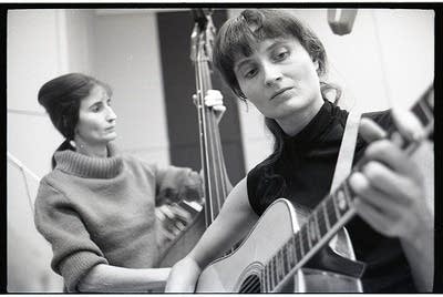 Two women playing stringed instruments