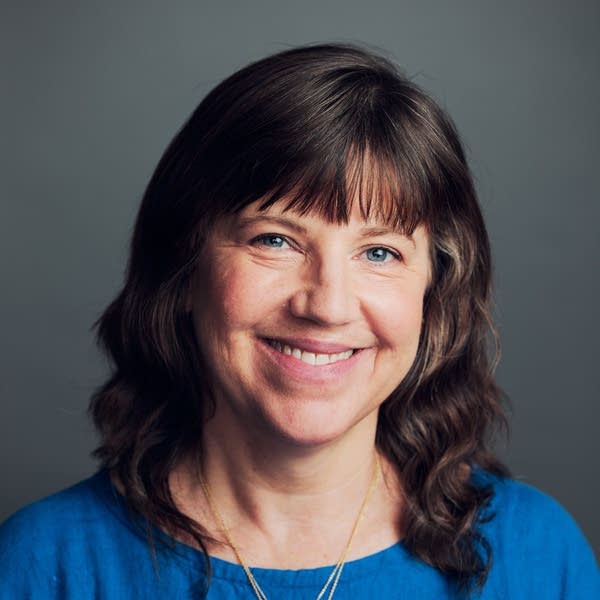 woman wearing blue poses for headshot 