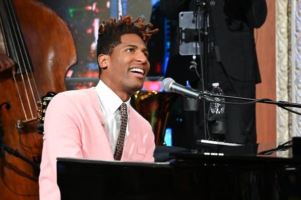 A man sings and plays piano