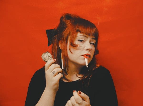 A woman smokes a cigarette