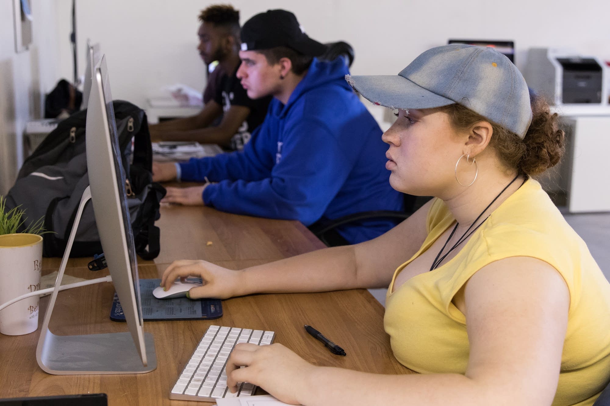 Senior designer Avahnii Lewis, 16, works on a brochure design.