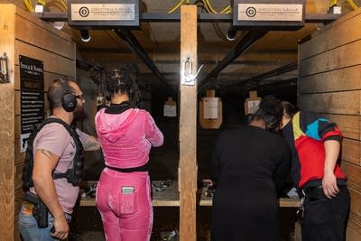 People shoot guns at a range-1
