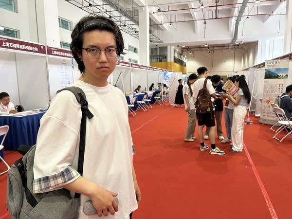 A college student poses at a job fair in Shanghai