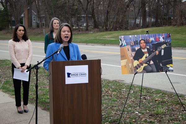A woman talks at the podium 