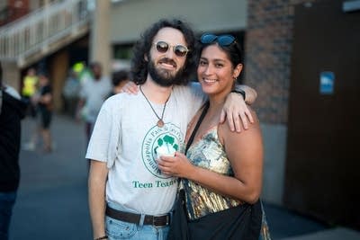 Two friends pose for a photo ahead of a concert at an outdoor music venue