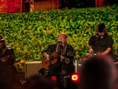 A group of musicians perform on the Farm Aid stage.