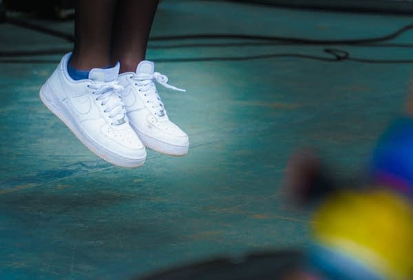 Clean, white Nikes worn by Jain, in the middle of a bouncing leap at the Container Bar in Austin, Texas during SXSW 2017.