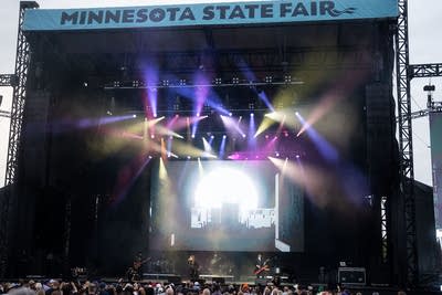 Jimmy Jam and Terry Lewis perform on an outdoor stage.
