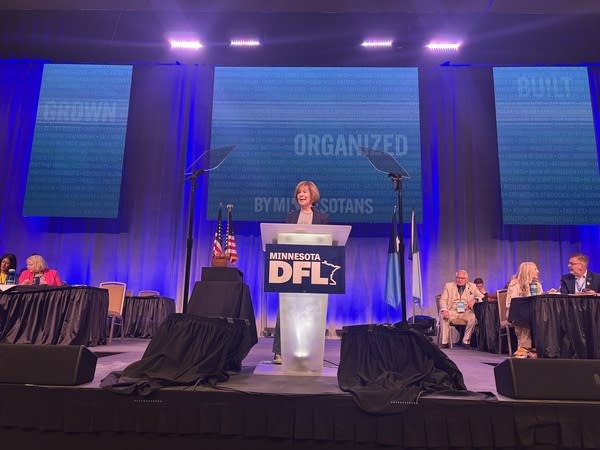 Tina Smith gives opening remarks on stage