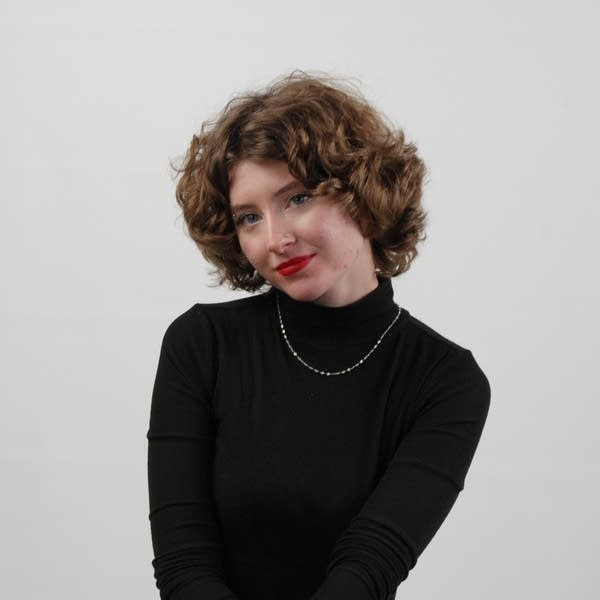 A woman poses for a portrait.