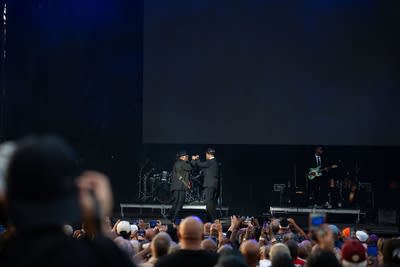 Jimmy Jam and Terry Lewis perform on an outdoor stage.