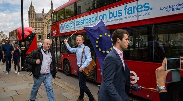 A man carries a European Union flag outside the Houses of Parliament on June 24, 2016 in London, United Kingdom. The result from the historic EU referendum has now been declared and the United Kingdom has voted to leave the European Union.