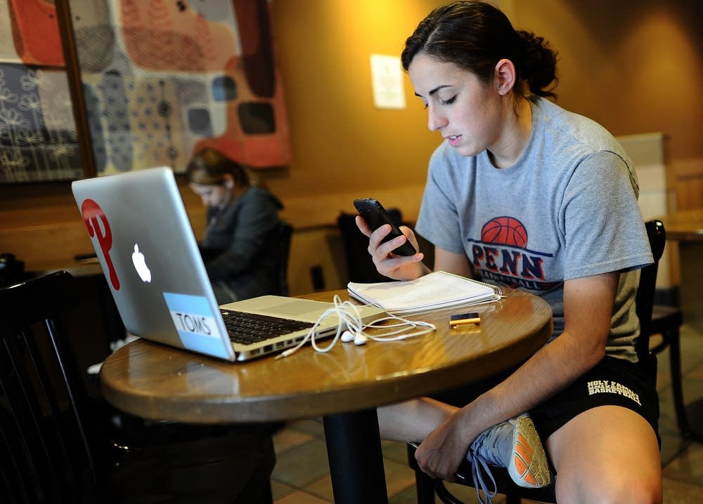 Woman on smartphone, laptop