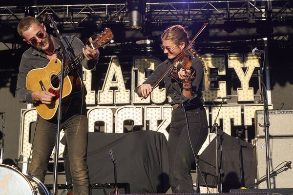 wild horses band playing on an outdoor stage