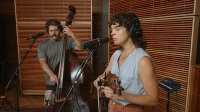 Two musicians performing together in a recording studio