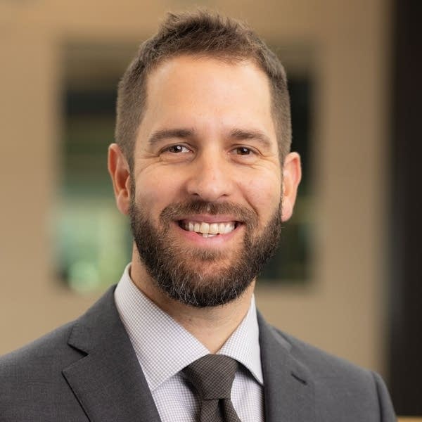 man with suit and tie poses for a portrait
