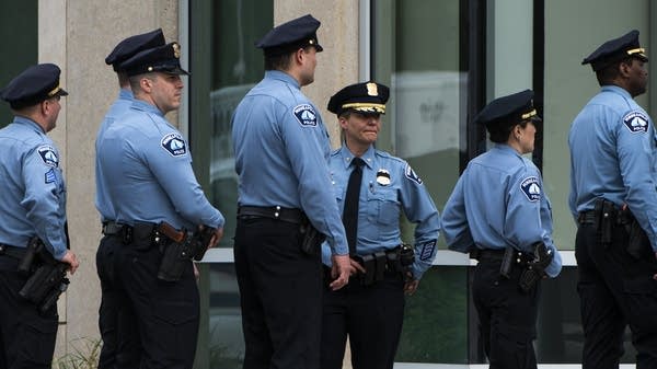 Members of the Minneapolis Police Department arrive at the funeral