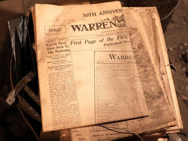 a faded, dust covered newspaper 