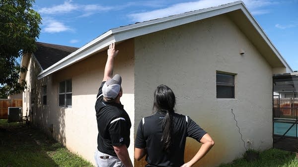 Zillow Offers Staffers J Myers and Claudia Teyssandier examine a home for a potential purchase. 