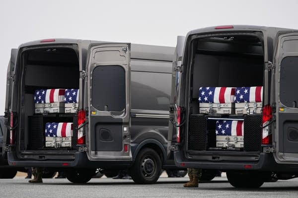 Transfer vans containing the remains of U.S. Army Reserve soldiers