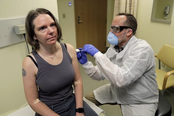 A woman gets a vaccine. 