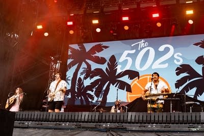 A band performing on a large outdoor stage