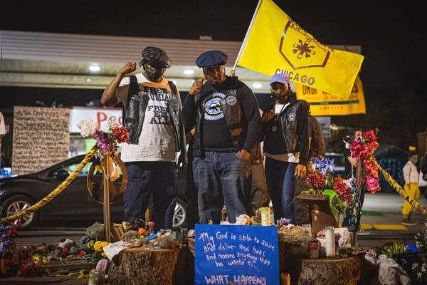 A group of people raise their fists