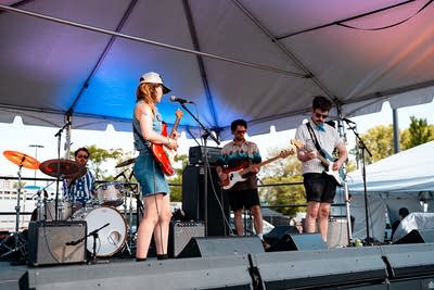A band performing on an outdoor stage