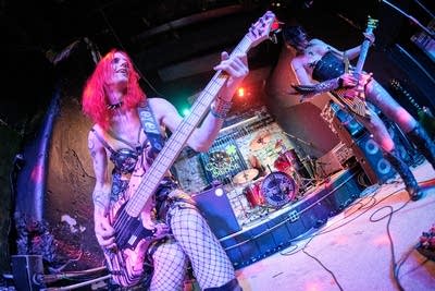 Three musicians performing onstage