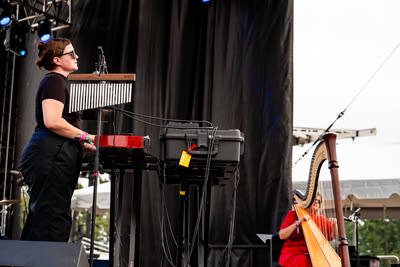 Julianna Barwick and Mary Lattimore performing on an outdoor stage.