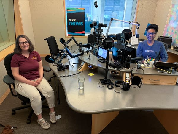 two women smiling in a broadcast studio