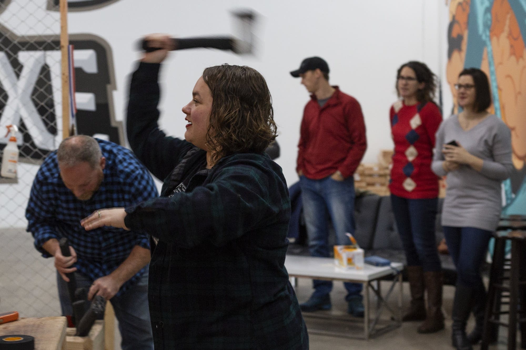 Angela Sylvester throws an axe at the bullseye at Bad Axe Throwing.