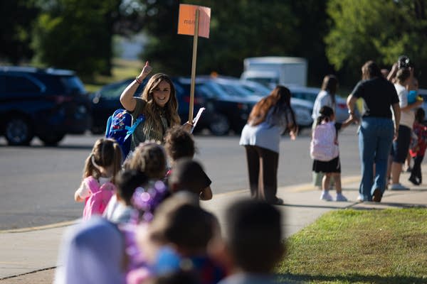 A teacher gives the thumbs-up