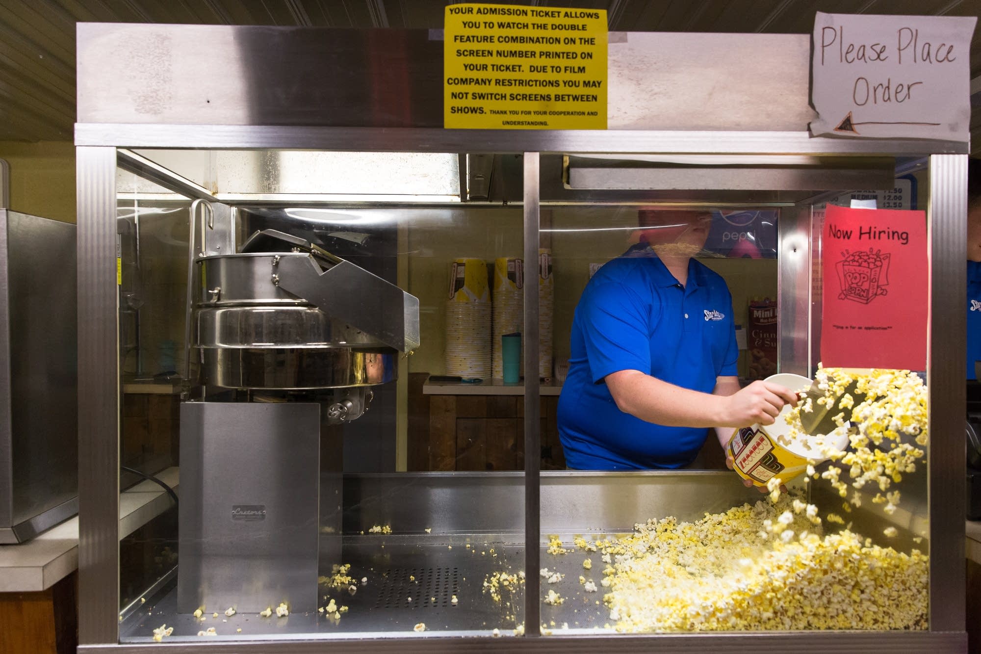 18-year-old Henry Fitzsimmons scoops popcorn for a customer.