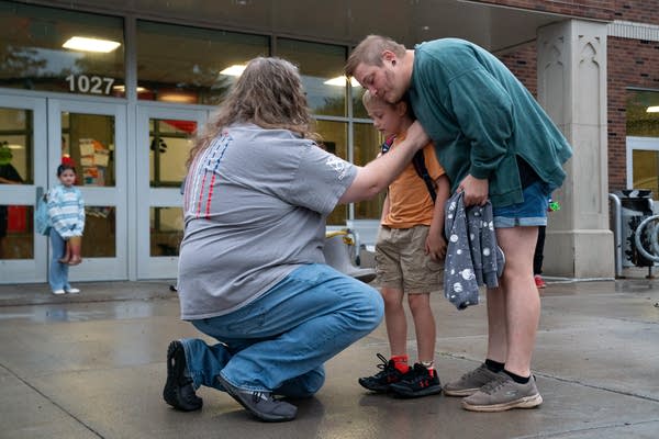 Parents drop their child off at school